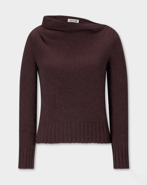Claude Knite, dark brown knit sweater with a wide draped neckline, long sleeves, and a ribbed hem and cuffs, shown against a light gray background.