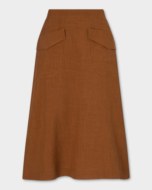 Kingma Skirt, rust-brown A-line skirt with two large angled front patch pockets, shown flat against a light gray background.