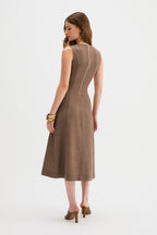 Laverne Midi Dress, a woman modeling a sleeveless taupe-brown midi dress from the back, showing a central seam detail, against a plain white studio background.
